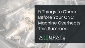 CNC technician performing summer maintenance on a vertical machining center to prevent CNC machine overheats